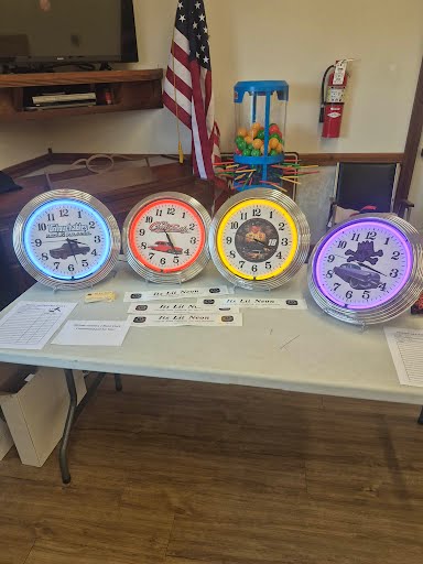 Lineup of custom neon clocks in blue, red, yellow, and purple